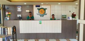 two people standing behind a counter in a library at Jungle Wildlife Camp in Sauraha