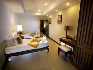 a hotel room with two beds and a desk at Smile House - Fisherman Village in Bophut