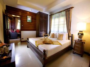 a bedroom with a bed with a towel on it at Smile House - Fisherman Village in Bophut