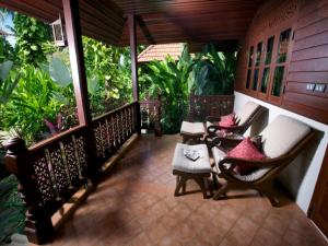 a porch with two chairs and pillows on it at Smile House - Fisherman Village in Bophut
