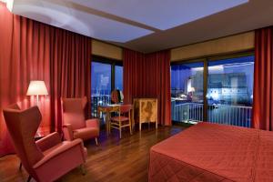 a hotel room with a bed and a balcony at Hotel Royal Continental in Naples