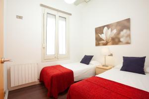 a bedroom with two beds and a window at Rent Top Apartments near Plaza de Catalunya in Barcelona