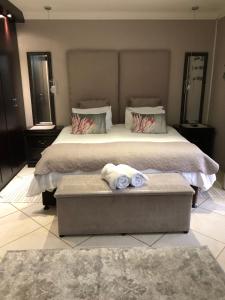 a bedroom with a bed with two towels on it at Annie's Place in Kempton Park