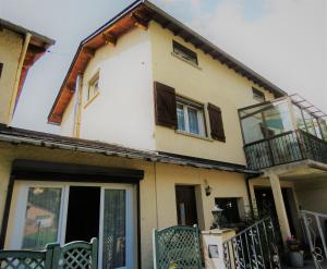 a house with two balconies on the side of it at Vaqué Villeneuve des Escaldes Angoustrine in Angoustrine