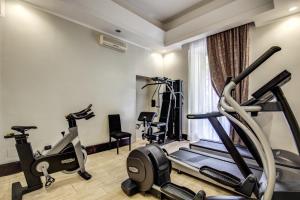 a gym with two exercise bikes and a treadmill at Hotel dei Quiriti in Rome
