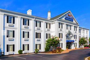 a white inn with a blue sign on it at Baymont by Wyndham Columbia Maury in Columbia