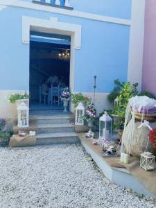ein Haus mit einer blauen Tür, einer Treppe und Blumen in der Unterkunft Vesta in Sorgono