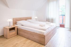 Posteľ alebo postele v izbe v ubytovaní Parkowa Polana MyWeek