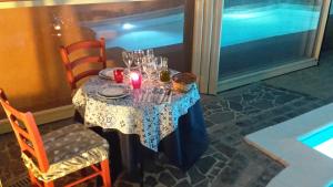 a table with wine glasses and candles on it at Villa Salvatore in San Leone