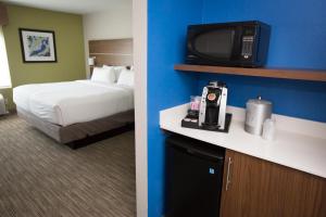 a hotel room with a bed and a tv at Holiday Inn Express Hotel & Suites Madison, an IHG Hotel in Madison