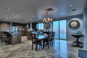 a kitchen and dining room with a table and a clock at Amazing Penthouse at Bella Sirena with Views and Entertainment - 901-C in Puerto Peñasco