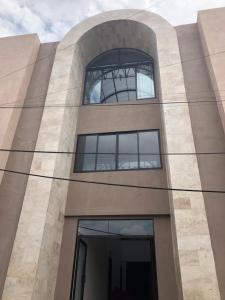 a building with a large window on the side of it at Hotel del Carmen in León