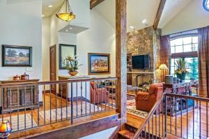 a large living room with a balcony and a living room at Snowmass Ski-In Ski-Out Condominiums in Snowmass Village