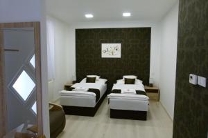 A bed or beds in a room at Wolf House Apartman
