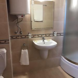 a bathroom with a sink and a mirror and a toilet at Apartment Lucy in Pamporovo +37 photos