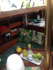 a table with a plate of apples and a bottle of water at Toucan in Pointe-à-Pitre