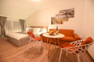 a living room filled with furniture and a table at Korzo apartmani in Podgorica