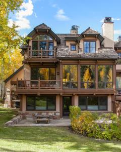 a large house with a wrap around porch at Snowmass Ski-In Ski-Out Condominiums in Snowmass Village