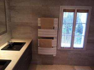 a kitchen with a sink and some boxes on the wall at La Fleur de Sel in La Flotte