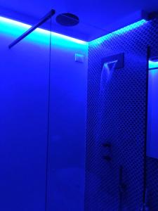 a bathroom with a shower with blue lights at MADA Charm Apartments Terrace&Carugio in Vernazza