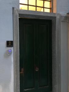 a green door with a sign on the side of a building at MADA Charm Apartments Terrace&Carugio in Vernazza