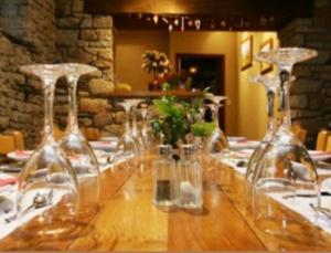 a long table with wine glasses on top of it at Auberge Saint Hernin in Pluherlin