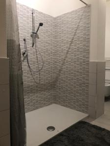 a bathroom with a shower with a shower curtain at Bari Lory’s Home in Bari