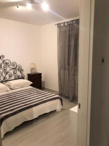 a bedroom with a bed and a window at Bari Lory’s Home in Bari
