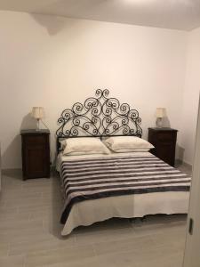 a bedroom with a large bed with a black headboard at Bari Lory’s Home in Bari