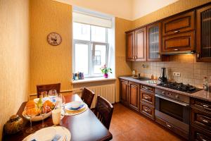 a kitchen with a table with a bowl of fruit on it at Old Riga Quiet Apartment in Riga