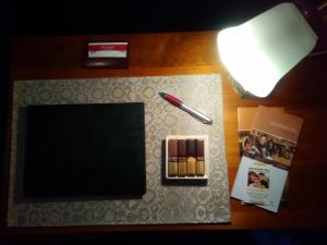 a desk with a pen and a notebook on it at Dunstans Guest House in Ballarat