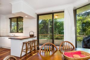 a kitchen and dining room with a table and chairs at Breeze@Byron 1 Clarkes Beach in Byron Bay