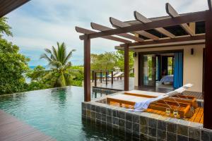 a villa with a swimming pool and a bed in the water at Aspire Villas in Salad Beach