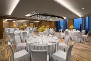 a banquet hall with white tables and white chairs at Ascott Riverside Garden Beijing in Beijing +37 photos
