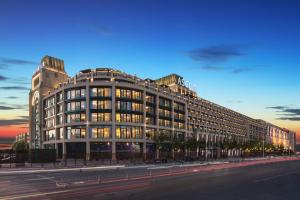 a large building on a city street at dusk at Ascott Riverside Garden Beijing in Beijing