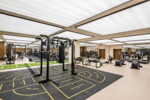 a gym with lots of treadmills and machines at Ascott Riverside Garden Beijing in Beijing