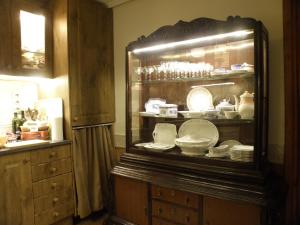 a cabinet filled with plates and dishes in a kitchen at La NANA del MAR / The LULLABY of the SEA on old harbour in Cudillero +266 photos
