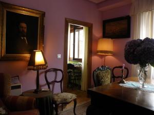 a living room with a painting of a man on the wall at La NANA del MAR / The LULLABY of the SEA on old harbour in Cudillero