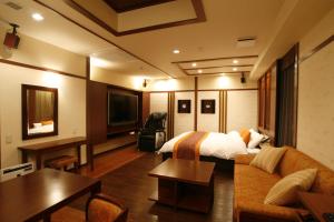 a hotel room with a bed and a couch at Hotel & Spa Lotus (Adult Only) in Kyoto