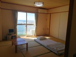 Giường trong phòng chung tại 海のお宿