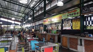 a restaurant with tables and people sitting at tables at Womy Homy in Bogor
