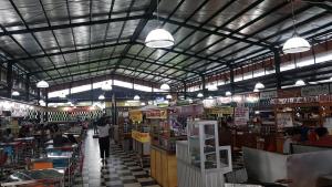 a book store with people walking through the aisle at Womy Homy in Bogor