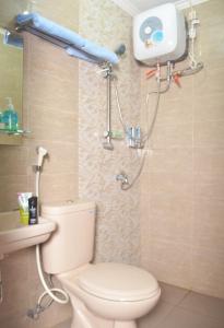 a bathroom with a toilet and a shower at Cihampelas Homestay in Bandung +33 photos