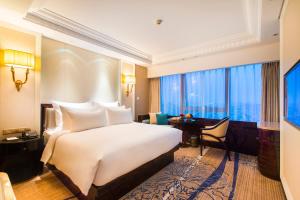Ένα ή περισσότερα κρεβάτια σε δωμάτιο στο Kasion International Hotel Yiwu