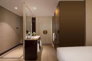 Ένα ή περισσότερα κρεβάτια σε δωμάτιο στο Kasion International Hotel Yiwu