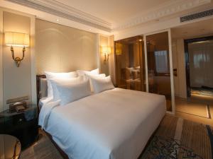 Ένα ή περισσότερα κρεβάτια σε δωμάτιο στο Kasion International Hotel Yiwu