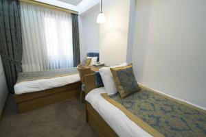 Postel nebo postele na pokoji v ubytování Cumbali Suite Hotel