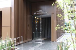 a building with a revolving door in front of it at Hotel Gracery Asakusa in Tokyo +68 photos