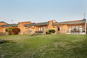 a brick house with a lawn in front of it at First Group Club Hacienda in Shelly Beach +52 photos