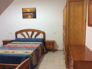 エル・ボスケにあるCasa Vicente el Bosqueの小さなベッドルーム(ベッド1台、テーブル付)